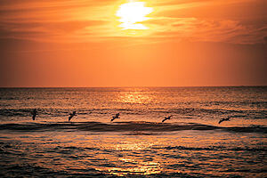 Beautiful sunrise washing over an Avon beach.